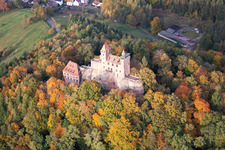 Aerial view of Ruins and vestiges of the former castle and fortress Burg Berwartstein in autumn colured forest in Erlenbach bei Dahn in the state Rhineland-Palatinate
