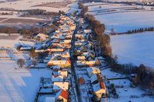 Village view from the west in winter with snow in Vollmersweiler in the state Rhineland-Palatinate, Germany