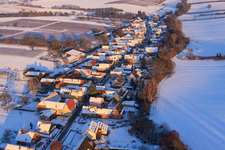 Oblique view of Village view from the west in winter with snow in Vollmersweiler in the state Rhineland-Palatinate, Germany