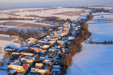 Village view from the west in winter with snow in Vollmersweiler in the state Rhineland-Palatinate, Germany from above