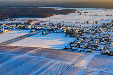 Raiffeisenstraße in winter with snow in Freckenfeld in the state Rhineland-Palatinate, Germany