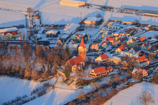 Protest. Church in winter with snow in Minfeld in the state Rhineland-Palatinate, Germany seen from above