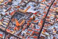 Primary school, town hall and St. George's Church on the market square in winter with snow in Kandel in the state Rhineland-Palatinate, Germany from above