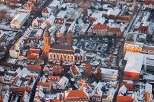Wintry snowy Church building in of Sankt Georgskirche, town-hall and primary school in Old Town- center of downtown in Kandel in the state Rhineland-Palatinate, Germany