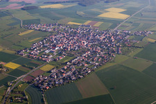 Aerial view of Village - view on the edge of agricultural fields and farmland in Kleinrinderfeld in the state Bavaria, Germany