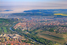 City view on both sides of the Main with vineyards from the south in the district Sanderau in Würzburg in the state Bavaria, Germany