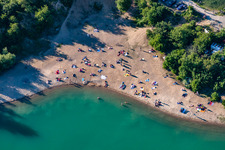 Aerial photograpy of Mass influx of nudist bathers on the beach and the shore areas of the lake Epplesee in Rheinstetten in the state Baden-Wurttemberg, Germany