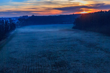 Oblique view of Otterbach lowlands in the morning mist at sunrise in Minfeld in the state Rhineland-Palatinate, Germany
