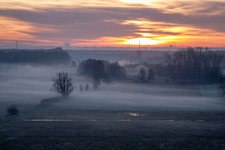 Colorful sunrise over the countryside in Minfeld in the state Rhineland-Palatinate dyes the sky orange and yellow