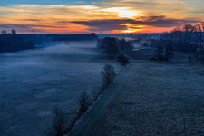 Otterbach lowlands in the morning mist at sunrise in Minfeld in the state Rhineland-Palatinate, Germany viewn from the air