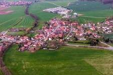 Aerial view of Village - view on the edge of agricultural fields and farmland in Simmershausen in the state Thuringia, Germany