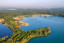 Aerial view of Fisherman's home, beach and Heidelberg Materials Mineralik at the Giessen quarry lake in the district Liedolsheim in Dettenheim in the state Baden-Wuerttemberg, Germany
