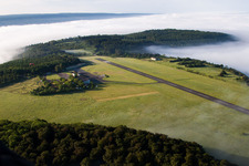 Aerial view of Runway with tarmac terrain of airfield Hoexter-Holzminden with morning mist in the district Brenkhausen in Hoexter in the state North Rhine-Westphalia, Germany