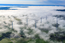Aerial view of Rotors of wind farm Fürstenau protrude from low clouds in the district Fürstenau in Höxter in the state North Rhine-Westphalia, Germany