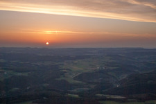 Sunset over the countryside in Ehingen (Donau) in the state Baden-Wurttemberg dyes the sky in a red and orange colour