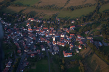 Aerial view of Village - view on the edge of agricultural fields and farmland in Breungeshain in the state Hesse