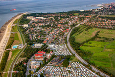 Rows of beach chairs on the sandy beach up to the Kugelbake in the coastal area of the North Sea with the campsites Wattenlöper and Nordsee in the foreground in the district Duhnen in Cuxhaven in the state Lower Saxony, Germany