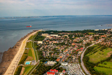 Rows of beach chairs on the sandy beach up to the Kugelbake in the coastal area of the North Sea with the campsites Wattenlöper and Nordsee in the foreground in the district Döse in Cuxhaven in the state Lower Saxony, Germany