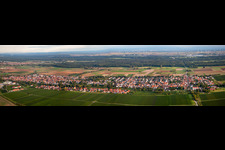 Aerial view of Panoramic perspective Village - view on the edge of agricultural fields and farmland in Hochstadt (Pfalz) in the state Rhineland-Palatinate, Germany