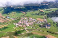 Aerial view of Village - view below low clouds on the edge of agricultural fields and farmland in the district Mauenheim in Immendingen in the state Baden-Wurttemberg, Germany