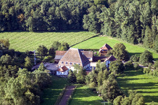 Historic watermill on a farm homestead on the edge of cultivated fields in the district Bienwaldmuehle in Scheibenhardt in the state Rhineland-Palatinate